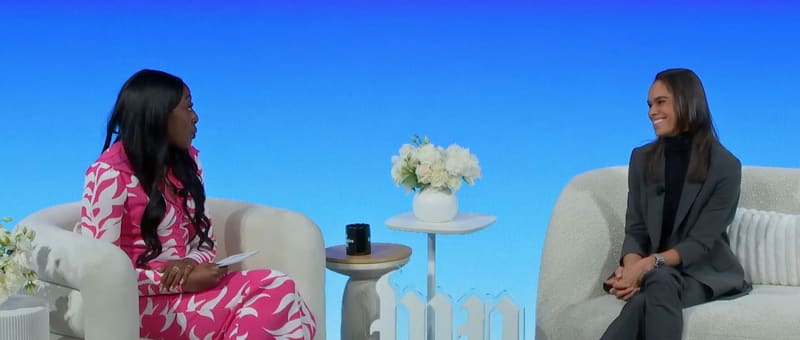 A frame from Washington Post Live’s stream of the Global Women’s Summit 2025: two women in conversation in white armchairs on a bright blue stage set.